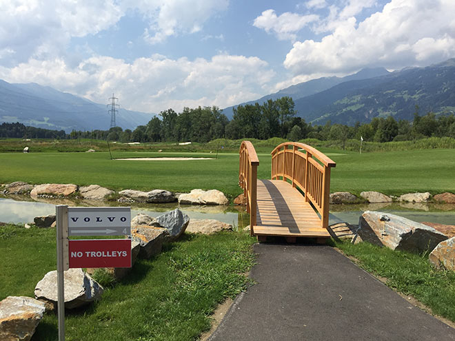 Der Weg aufs Inselgrün führt über eine urige Holzbrücke. Dolomitengolf Course Volvo, Loch 3